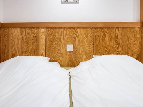 Una cama o camas en una habitación de Susukinohara Ichinoyu