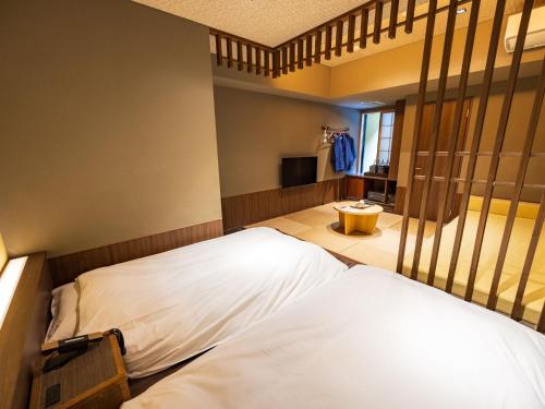 Una cama o camas en una habitación de Susukinohara Ichinoyu