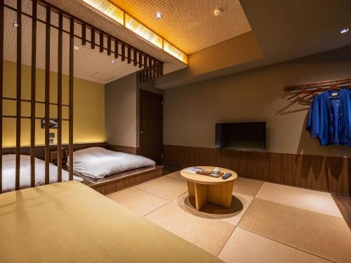 Una cama o camas en una habitación de Susukinohara Ichinoyu