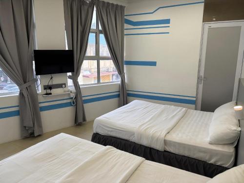 One Stop Hotel Ipohにあるベッド