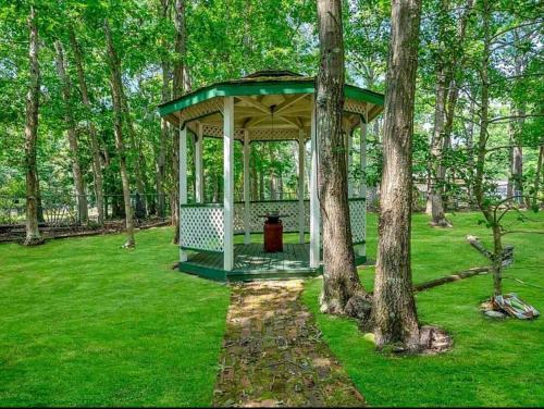 a gazebo in the middle of a park with trees at Cozy & Private Retreat Near Atlantic City! in Galloway