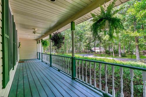 a porch of a house with a green deck at Cozy & Private Retreat Near Atlantic City! in Galloway