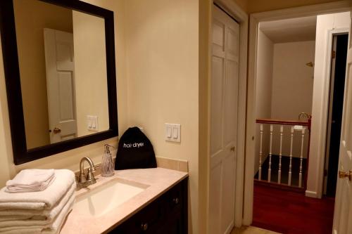a bathroom with a sink and a large mirror at Cozy & Private Retreat Near Atlantic City! in Galloway