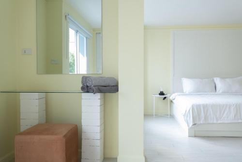 a bedroom with a bed and a mirror on the wall at Baan Khun Pra APT No4 Duplex 3BR in Bangkok