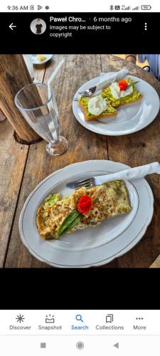 a picture of two plates of pizza on a table at Aaliya Bay in Arugam Bay