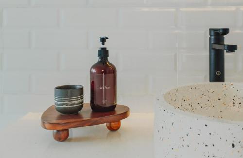 a bottle of wine on a table next to a sink at Spacious luxury Canggu villa 3BR crate cafe, beach 10min in Canggu