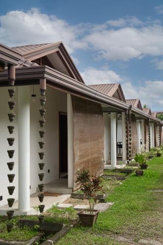 a row of houses with white columns at Bali Villa Mirissa in Mirissa