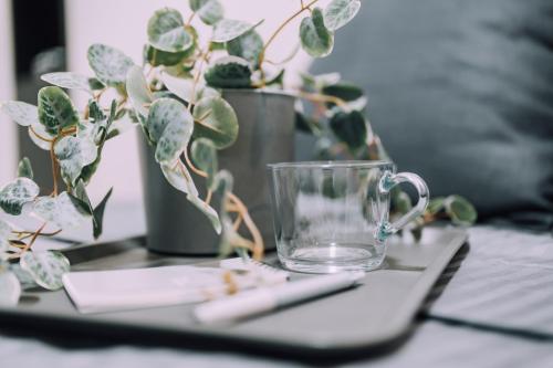 a table with a glass mug and a remote control at Minimalist Loft Namba Compact Studio with a 24-hour Gym MA1003 in Osaka