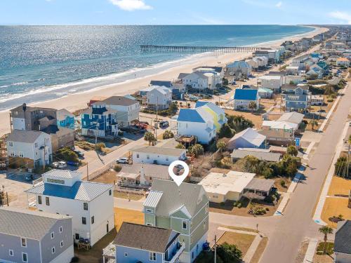 an aerial view of a beach with houses and the ocean at Shore Sounds Fun in Surf City