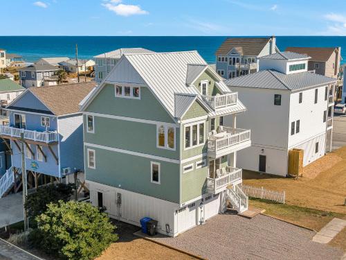 an aerial view of a house in front of the ocean at Shore Sounds Fun in Surf City