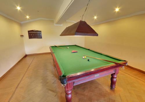a room with a pool table in a room with a ceiling at Tea county in Munnar