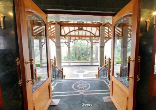 an open door to a house with a porch at Tea county in Munnar