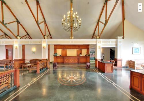 a large room with a chandelier and a courtroom at Tea county in Munnar