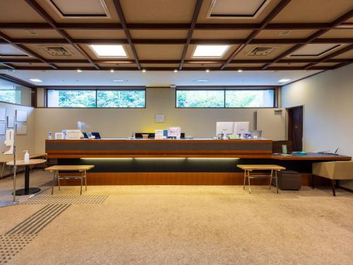 a waiting room with a reception counter and tables at Hakoneji Kaiun in Hakone