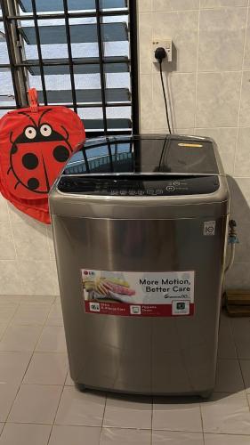 a metal trash can with a ladybug on it at Destiny Guesthouse Kuching Near Airport 4pm checkout in Kuching