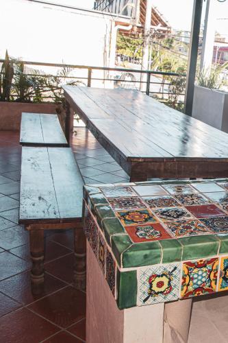 two tables and a bench sitting on a patio at Hotel Tulum Centro, Party Hotel in Tulum