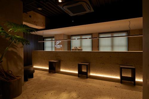 a room with a counter with lights on it at TONES Osaka in Osaka