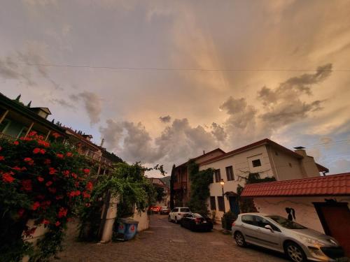 a cloudy sky with cars parked on a street at Betlemi25 in Tbilisi City