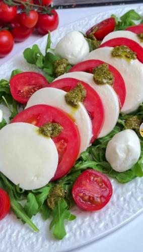 a plate of food with radishes and other vegetables at Hotel Bar Restaurant Stone Dream in Udënisht