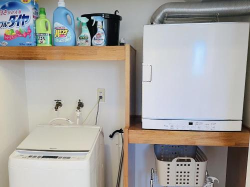 a small kitchen with a sink and a microwave at Ocean Terrace金武 in Kin