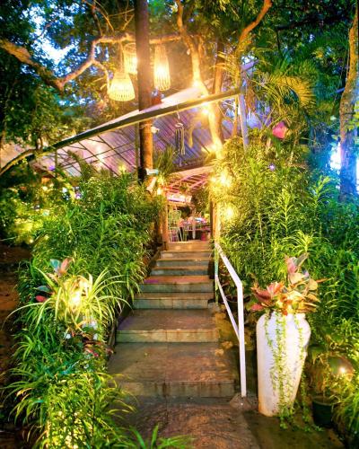a stairway in a garden with plants and lights at Lar Amorosa Boutique Hotel - Goa in Calangute