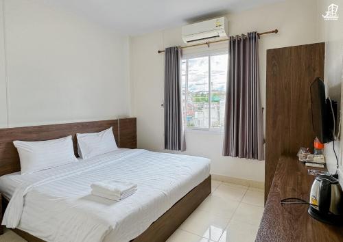 Postel nebo postele na pokoji v ubytování Jacky Chan Hotel