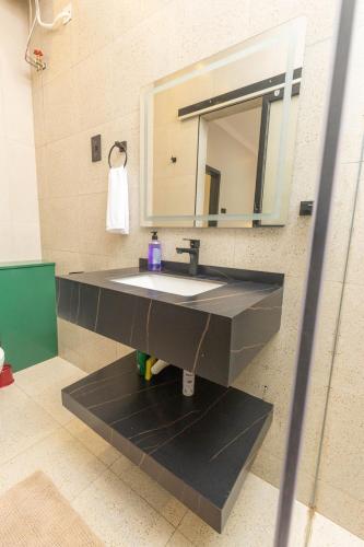 a bathroom with a sink and a mirror at Serenity Haven Najeera in Kira