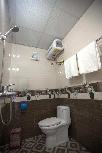 a bathroom with a toilet and a shower at Moc May by Northstar Hostel & Tours in Ha Giang