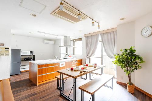 a kitchen with a table and a dining room at en stay003 in Osaka