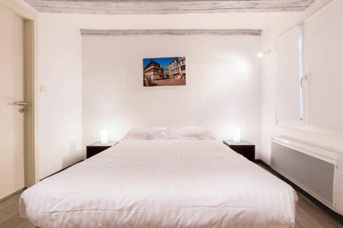 a white bedroom with a large bed with two lamps at COLMAR city center Little Venise - GITE DE LEA - in Colmar