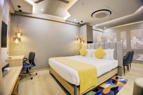 a hotel room with a bed and a desk at Cozzet Mahad in Mahad