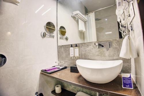 a bathroom with a white sink and a mirror at Cozzet Mahad in Mahad