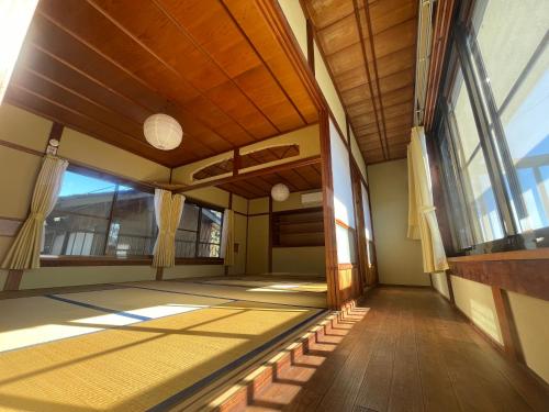 an empty hallway of a house with windows at NAMIOTO Kumano-Kodo Beachfront Rental House in Kumano
