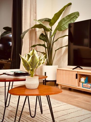 a living room with a coffee table and a tv at Luxe & Bright Gem - Prime Location, Roof Deck, View in Seattle