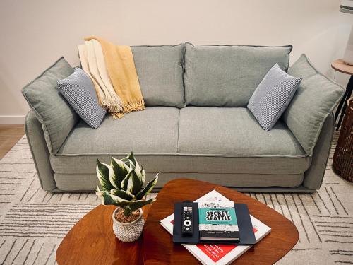 a living room with a couch and a coffee table at Luxe & Bright Gem - Prime Location, Roof Deck, View in Seattle