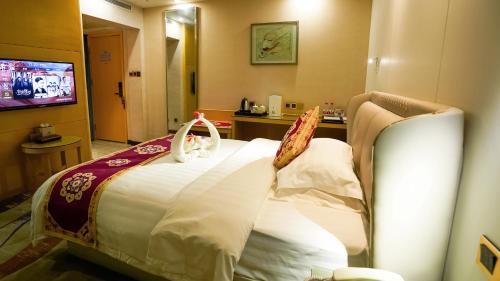 a hotel room with a bed in a room at Dunhuang Hotel in Dunhuang