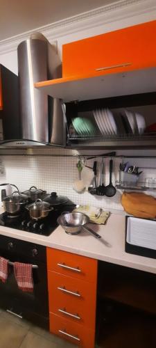 a kitchen with a stove with pots and pans on it at Шикарная 2к квартира Центральный парк Университет 70м in Irpin'