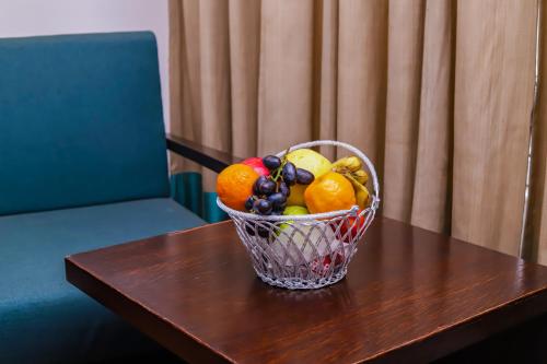 a basket of fruit sitting on top of a table at Hotel Godwin Deluxe - Free Airport Pick-Up in New Delhi