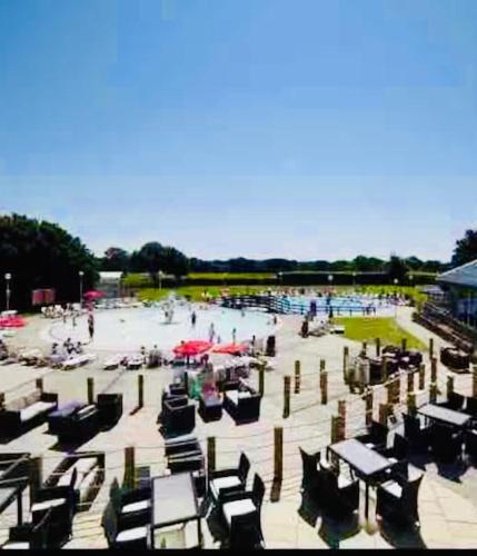 a group of people in a pool with umbrellas at NEW FOREST Hoburne Bashley Holiday Park, Spacious Caravan Sycamore 201 Sleeps 6 in New Milton