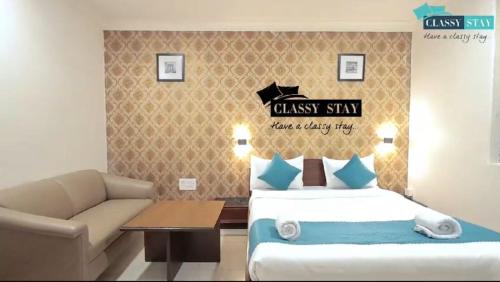 a bedroom with a king sized bed and a couch at Manas Residency Classy Stay in Mumbai