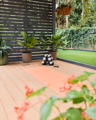 a teddy bear sitting on a deck with plants at Villas Roca del Caribe in Puerto Viejo