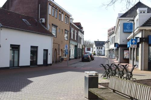 a street in a town with benches and buildings at B&B 't Morregaât in Weert