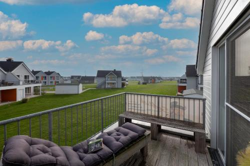 a balcony with a bench and a view of a field at Fewo Kapitän James Cook Olpenitz in Kappeln