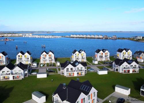 an aerial view of a town with houses and the water at Fewo Kapitän James Cook Olpenitz in Kappeln