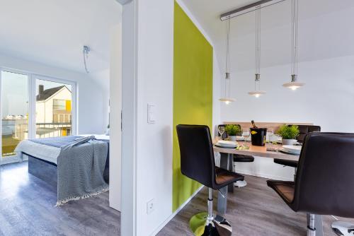 a bedroom with a desk and chairs in a room at Fewo Kapitän James Cook Olpenitz in Kappeln