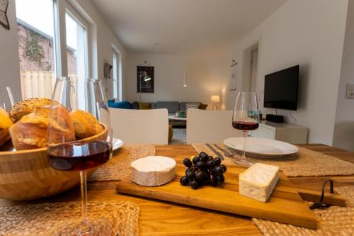 a table with wine glasses and bread and cheese at Lykke Lys in Heiligenhafen