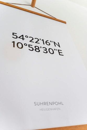 a piece of paper with a wooden stick on it at Lykke Lys in Heiligenhafen