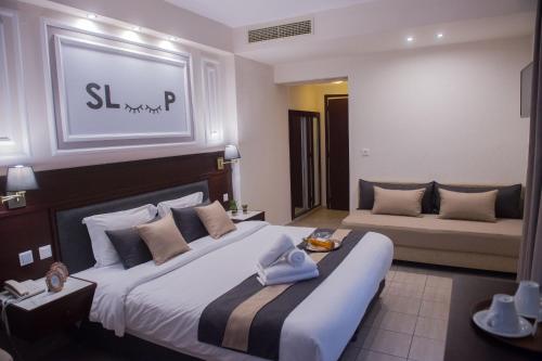 a bedroom with two beds in a hotel room at Sokratis Hotel in Nea Moudania