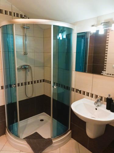a bathroom with a shower and a sink at Penzión Turzov in Gelnica