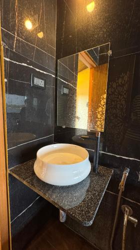 a bathroom with a sink and a mirror at Vistara Beach Resort Malpe - Udupi in Udiyāvara